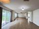 Bright living room with tile floors, a ceiling fan, and sliding glass doors to the backyard at 1325 Bella Coola Dr, Orlando, FL 32828