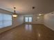 Bright living room with tile floors, large windows, and a decorative chandelier at 1325 Bella Coola Dr, Orlando, FL 32828