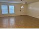 Bright living room features tile flooring, two large windows and a front door at 1325 Bella Coola Dr, Orlando, FL 32828