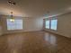 Bright living room with tile floors, large windows, and a decorative chandelier at 1325 Bella Coola Dr, Orlando, FL 32828