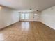 Bright living room features tile flooring and ample natural light from large windows at 1325 Bella Coola Dr, Orlando, FL 32828