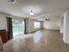Bright living room with tile flooring, neutral paint, and sliding glass door to backyard at 1325 Bella Coola Dr, Orlando, FL 32828