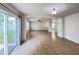 Bright living room featuring a sliding glass door to the backyard, and passthrough to another living space at 1325 Bella Coola Dr, Orlando, FL 32828