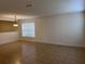 Bright living room with tile flooring, window and stairs leading to second level at 1325 Bella Coola Dr, Orlando, FL 32828