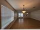 Bright living room features tile flooring, two large windows, and hanging light fixture at 1325 Bella Coola Dr, Orlando, FL 32828