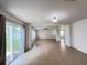 Bright living room with tile floors, ceiling fan, and sliding glass doors to the backyard at 1325 Bella Coola Dr, Orlando, FL 32828