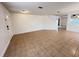 Open-concept living room with tile flooring, stairs, and adjacent room view at 1325 Bella Coola Dr, Orlando, FL 32828