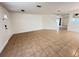Open-concept living room with tile flooring, featuring stairs and entrance at 1325 Bella Coola Dr, Orlando, FL 32828