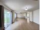 Bright living room with tile floors, a ceiling fan, and sliding glass doors to the backyard at 1325 Bella Coola Dr, Orlando, FL 32828