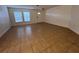 Bright living room features tile flooring, two large windows and a front door at 1325 Bella Coola Dr, Orlando, FL 32828