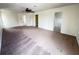 This expansive living room features neutral walls, a ceiling fan, and convenient access to other areas at 1325 Bella Coola Dr, Orlando, FL 32828