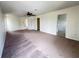 Spacious living room featuring neutral walls, ceiling fan, and multiple entryways for convenience at 1325 Bella Coola Dr, Orlando, FL 32828