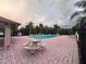 Community pool featuring a picnic table, lounge chairs, and lush landscaping at 1325 Bella Coola Dr, Orlando, FL 32828