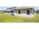 A view of the side and back of the home showcasing the spacious yard and exterior features at 13851 Rushing Creek Run, Orlando, FL 32824