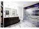 Bathroom featuring dual vanity, marble tile, and a walk-in shower at 13851 Rushing Creek Run, Orlando, FL 32824