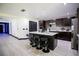 Kitchen with dark cabinets, stainless appliances, island with seating and modern backsplash at 13851 Rushing Creek Run, Orlando, FL 32824