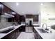 Beautiful kitchen with dark cabinets, stainless appliances and modern backsplash at 13851 Rushing Creek Run, Orlando, FL 32824