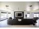 Large living room with a modern entertainment center, a sleek sectional sofa, and a wall of windows at 13851 Rushing Creek Run, Orlando, FL 32824