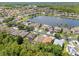 Aerial view of the property located near a scenic lake and community at 14780 Hartford Run Dr, Orlando, FL 32828