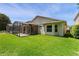 The backyard offers a screened-in patio and lush green grass at 14780 Hartford Run Dr, Orlando, FL 32828