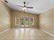 Large, naturally bright, living area with tile flooring and ceiling fan at 14780 Hartford Run Dr, Orlando, FL 32828