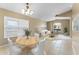 Bright living room with natural light from large window, dining table and plush seating at 14780 Hartford Run Dr, Orlando, FL 32828