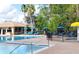 Resort-style pool area with lounge chairs, umbrellas, and lush landscaping perfect for relaxing or entertaining at 14780 Hartford Run Dr, Orlando, FL 32828