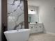 Modern bathroom featuring a freestanding tub, statement wall design, and double vanity with contemporary fixtures at 16494 Sw 54Th Court Rd, Ocala, FL 34473