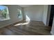 Bright bedroom featuring wood-look floors and natural light from two windows at 16494 Sw 54Th Court Rd, Ocala, FL 34473