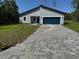 Charming single-story home with a blue garage door and a well-manicured front lawn at 16494 Sw 54Th Court Rd, Ocala, FL 34473