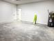 Unfinished garage space featuring concrete floor, block walls, and water heater at 16494 Sw 54Th Court Rd, Ocala, FL 34473