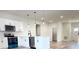Open concept kitchen with modern appliances, white cabinets, and an inviting layout at 16494 Sw 54Th Court Rd, Ocala, FL 34473