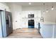 Modern kitchen with stainless steel appliances, sleek cabinets, and quartz countertops at 16494 Sw 54Th Court Rd, Ocala, FL 34473