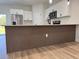 Modern kitchen island featuring elegant waterfall countertop and a stylish wood-finished base at 16494 Sw 54Th Court Rd, Ocala, FL 34473