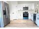 Beautiful kitchen with stainless steel appliances, white cabinets, and stylish fixtures at 16494 Sw 54Th Court Rd, Ocala, FL 34473