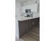Bright kitchen boasts white cabinetry, stainless steel appliances, quartz countertops, and stylish wood paneling on the island at 16494 Sw 54Th Court Rd, Ocala, FL 34473