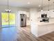 Open kitchen featuring stainless steel appliances, white cabinets, and center island at 16494 Sw 54Th Court Rd, Ocala, FL 34473