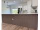 Modern kitchen island featuring elegant waterfall countertop and a stylish wood-finished base at 16494 Sw 54Th Court Rd, Ocala, FL 34473