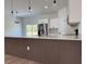 Modern kitchen island featuring elegant waterfall countertop and a stylish wood-finished base at 16494 Sw 54Th Court Rd, Ocala, FL 34473