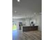 Open concept living area featuring recessed lighting, wood flooring, and a kitchen island with modern finishes at 16494 Sw 54Th Court Rd, Ocala, FL 34473