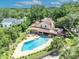 Aerial view of a beautiful home featuring a pool, a spacious backyard, and lush surrounding greenery at 1905 Old Club Pt, Maitland, FL 32751
