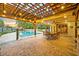 Backyard pool and patio area with covered dining area and string lights at 1905 Old Club Pt, Maitland, FL 32751