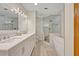 Modern bathroom featuring a double vanity, glass-enclosed shower, and a standalone tub for a luxurious experience at 1905 Old Club Pt, Maitland, FL 32751