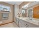Classic bathroom with double sinks and a vanity with a large mirror at 1905 Old Club Pt, Maitland, FL 32751