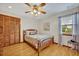 Comfortable bedroom with wooden floors, a ceiling fan, and natural light at 1905 Old Club Pt, Maitland, FL 32751
