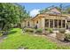 Exterior shows the manicured yard and patio area, with plants, flowers, and mature trees at 1905 Old Club Pt, Maitland, FL 32751