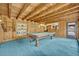 Bright game room showcasing wood paneled walls, a pool table, and access to outdoor amenities at 1905 Old Club Pt, Maitland, FL 32751