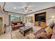 Cozy living room with leather furniture, ceiling fan, and pool view at 1905 Old Club Pt, Maitland, FL 32751