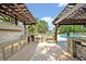 Outdoor kitchen with built in grill and bar and view of pool at 1905 Old Club Pt, Maitland, FL 32751