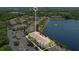 Aerial view highlighting the apartment complex, lake, trees, and ample parking at 1979 Summer Club Dr # 111, Oviedo, FL 32765